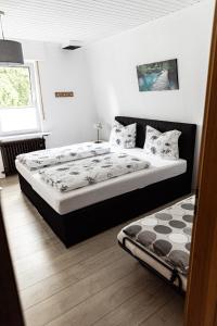 a bedroom with a large bed and a window at Anil‘s Ferienhaus in Olsberg