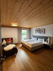 a bedroom with a large bed and a couch at Ferienwohnung Florina in Galtür