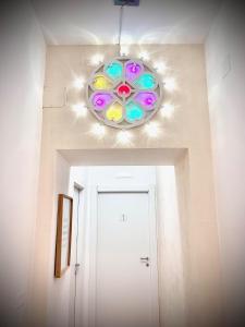 um lustre pendurado sobre um corredor com uma porta em D'Angiò Rooms-Manfredi Homes&Villas em Manfredonia