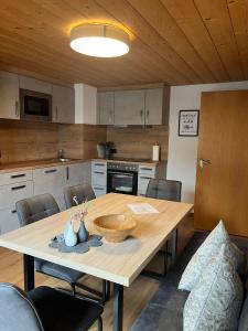 a kitchen with a wooden table with chairs around it at Ferienwohnung Florina in Galtür