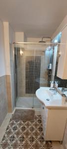 a bathroom with a shower and a sink and a tub at La Casina in Fornello
