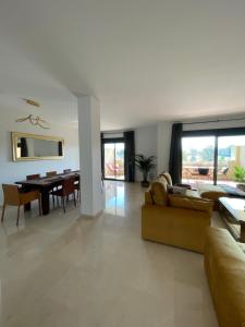 uma sala de estar com um sofá e uma sala de jantar em Casa de Loros em Marbella