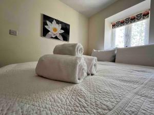 a bedroom with a bed with towels on it at Abercrymlyn barn in Llanwrda