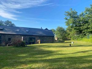 a brick house with a large yard in front of it at Crymlyn barn in Llanwrda