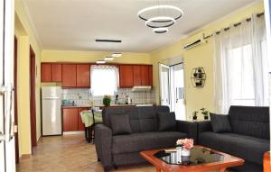a living room with two couches and a kitchen at Didda's Apartment in Orfánion