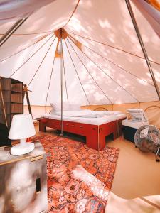 DOMO CAMP Sylt - Glamping Camp في Westerwall: غرفة بسرير في خيمة