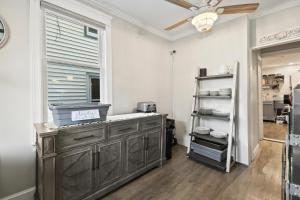 a kitchen with a large wooden cabinet and a window at The Inn at Ocean Grove in Ocean Grove