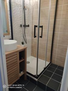 a bathroom with a shower and a sink at Beau studio cabine cozy in Chamrousse