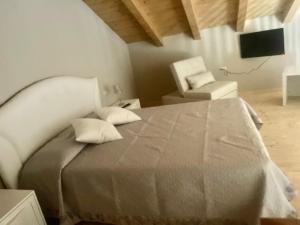 a bedroom with a bed and a chair in a room at Il Rifugio Del Certosino in Padula
