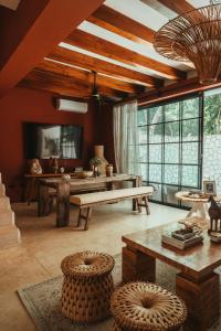 a living room with a bench and a table at The Lund Tulum in Tulum