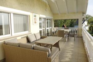 patio con mesa y sillas en el balcón en Sunny Beach Villa, en Szántód