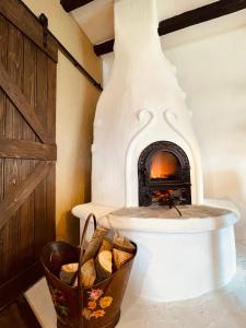 a fireplace in a room with a basket of bread at Inside, The Village- Atelier 