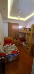 a bedroom with two bunk beds and a ceiling at Porto golf Marina بورتو جولف مارينا in El Alamein