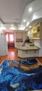 a kitchen with a blue rug on the floor at Porto golf Marina بورتو جولف مارينا in El Alamein