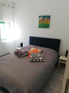a bed with pillows on it in a bedroom at Lory in Sveti Lovreč Pazenatički