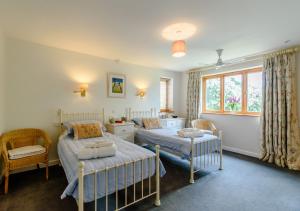 a bedroom with two beds and a window at Brights Farm Lodge in Bramfield