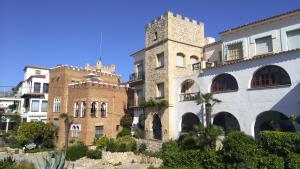 a building with a clock tower on top of it at Suitur Apartamento Roc Sant Gaietà I in Roda de Bará