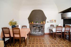 a dining room with a table and a fireplace at Pensione Solaria in Locarno