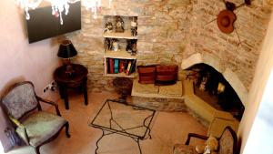 an overhead view of a living room with a stone fireplace at DonQuihotel Chalet in Karvounádhes