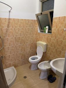 a bathroom with a toilet and a sink at Dibra Home near City Center of Shkodra in Shkodër