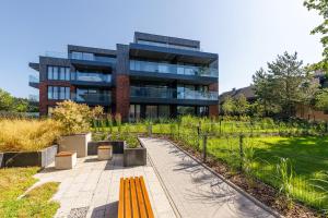 a building with a yellow bench in front of it at Sielsko Tu - Warmiński Port #13 in Olsztyn