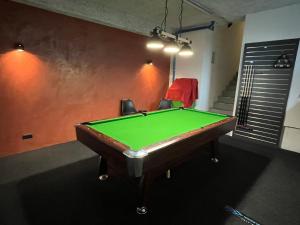 a pool table in a room with a green at Apartment Enarina in Telfs in Telfs