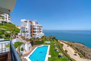 a view of a resort with a swimming pool and the ocean at Calaceite 3121 Ocean Paradise Casasol in Torrox Costa