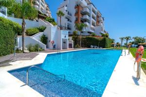 a swimming pool in front of a building at Calaceite 3121 Ocean Paradise Casasol in Torrox Costa