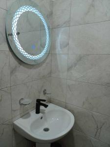 a bathroom with a white sink and a mirror at Shamil House in Makhinjauri +123 photos