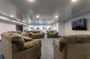 a large living room with couches and a flat screen tv at LOFTSatJC next to BU and UHS Wilson and Lourdes in Johnson City