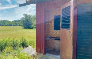 a out house with a sink in a field at Amazing Home In Figeholm With 2 Bedrooms in Figeholm
