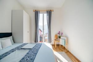 Schlafzimmer mit einem Bett und einem Fenster in der Unterkunft Pensione Solaria in Locarno