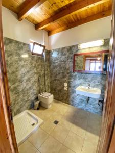 a bathroom with a toilet and a sink at XENIA HOTEL in Sfakia +49 photos