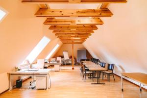 an attic office with tables and chairs and skylights at DOMO CAMP - Nature Glamping Hof Viehbrook in Rendswühren