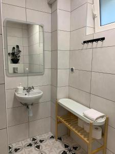 a white bathroom with a sink and a mirror at Dom na Północy in Władysławowo