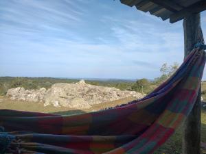 a hammock with a view of a mountain at Las Carobas in Minas