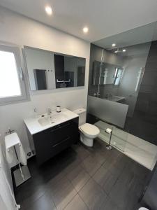 a bathroom with a sink and a toilet and a shower at Can Sastre in El Port