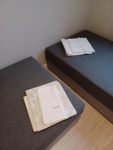 2 letti in una camera con un libro sul letto di Kołobrzeg Apartamenty Monada, Towarowa 50m od morza a Kołobrzeg