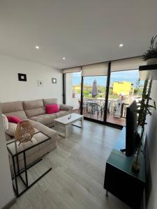 a living room with a couch and a tv in it at Can Sastre in El Port