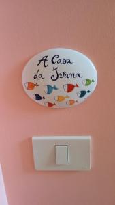 a fish plate on a wall with a lightswitch at A casa da Ivana in Vasto +2 photos