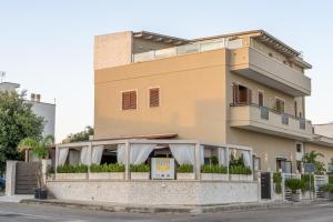 a building with a restaurant in front of it at B&B Alle Calende Greche in Martignano