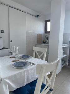 a dining room table with a white table cloth on it at Studio Apartman Lana 3 in Ičići