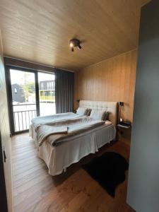 a bedroom with a large bed and a large window at Idre Northpark in Idre
