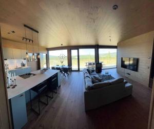 a kitchen and living room with a couch and a table at Idre Northpark in Idre +11 photos