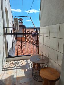 a balcony with a table and two stools at Apartma Koper2 with parking in Koper