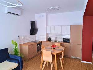 a living room with a table and a kitchen at Apartament Rubin in Zator