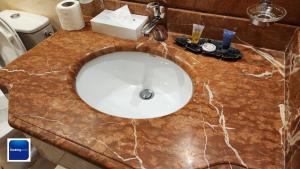a bathroom sink with a marble counter top at قصر لازورد للشقق المخدومة in Taif +20 photos
