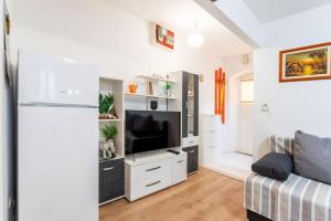 a living room with a tv and a couch at Apartment Giardino in Split
