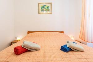 two pillows on a bed in a bedroom at Apartment Giardino in Split