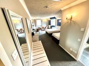 una camera da letto, un letto e uno specchio di South Lawn Hotel a Lymington